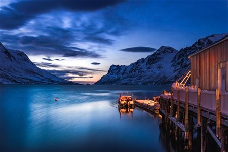 A boat, mountains and sea in the Tromso region