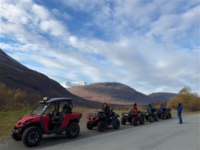 A line of quadbikes with guests on them