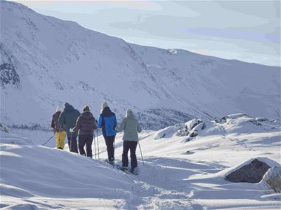 A group of guests explores the winter landscape on snowshoes.