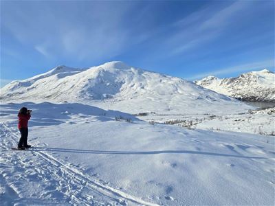A guest enjoys views across the snow-covered landscape during the snowshoeing tour.