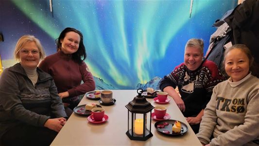 Four people sitting around a table at a café