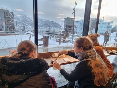 Three people sitting at a café eating