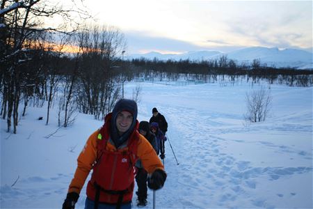 Smiling guide leading a group of guests