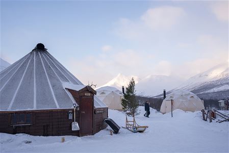 Camp Tamok surrounded by snow-covered mountains in Tamokdalen