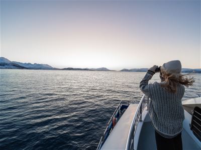 A guest enjoys the sea views from the deck of MV Quest.
