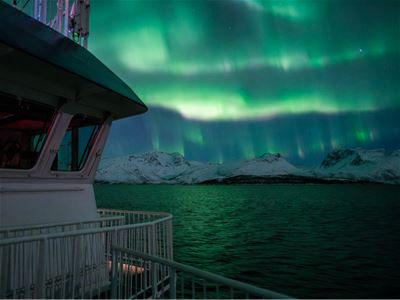 Northern Lights above the fjord viewed from the deck of MV Quest.