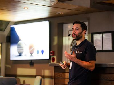 The expedition guide shares knowledge about Arctic nature and wildlife during the cruise.