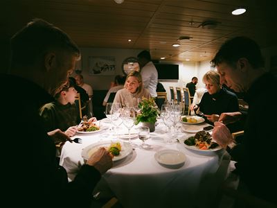 Guests enjoy dinner together on board MV Quest during the cruise.