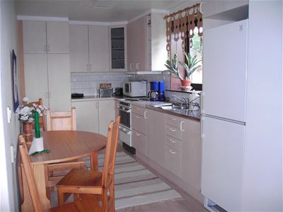 A kitchen with a dining table.