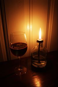 A glas of red wine and candle