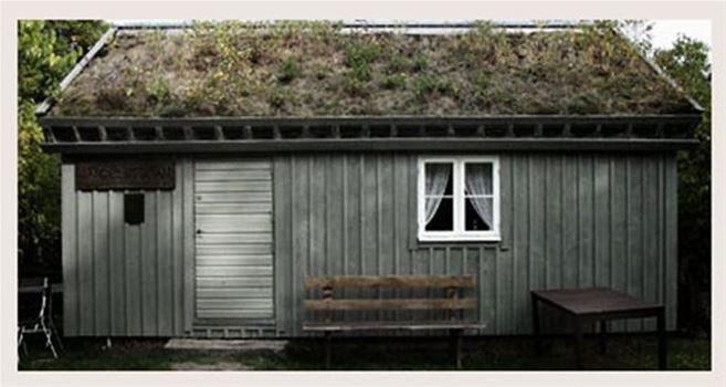 en bild på Jändelstugan som har gräs på taket 