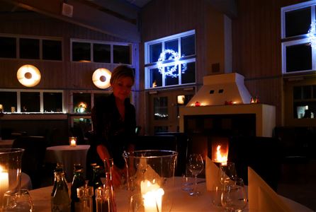 A waitress serving in the restaurant at night.