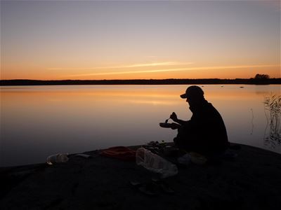 Man eating during sunset.