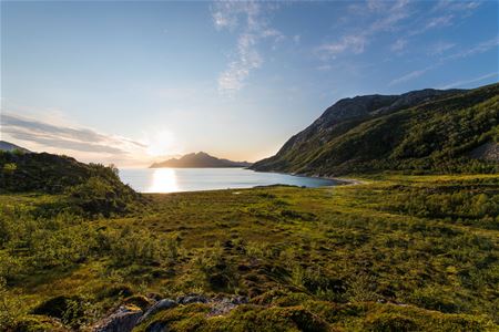 Sun is shining over the ocean and mountains