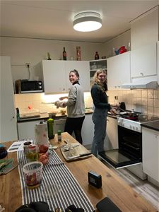 A couple making food.