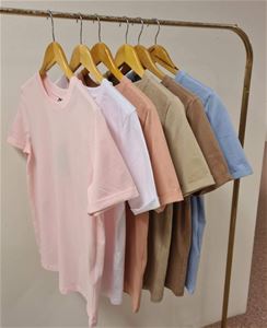 Färgbild - kläder hängande på klädställ