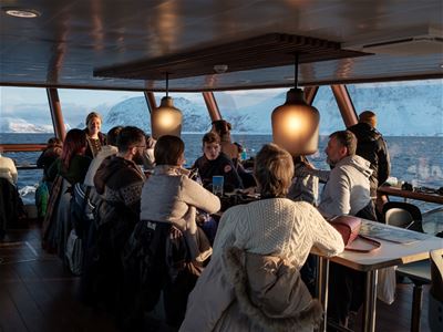 Guests relaxing in the heated saloon on board
